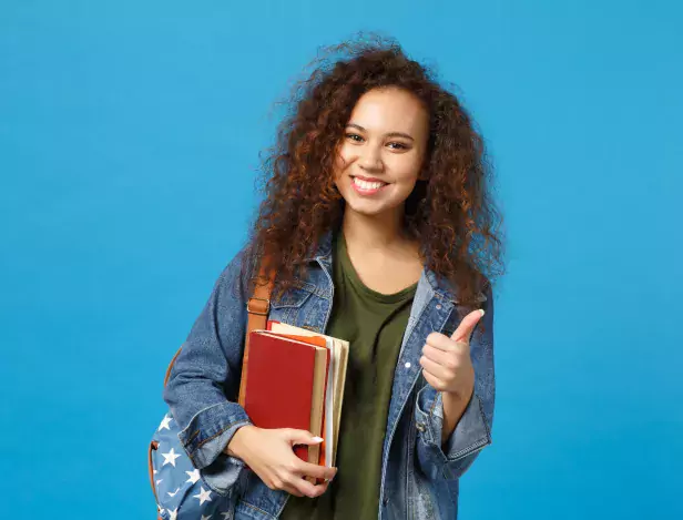 young-woman-student-denim-clothes-backpack-holds-books-isolated-blue-wall
