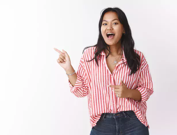 excited-girl-telling-about-awesome-sale-amused-and-joyful-pointing-left-as-inviting-go-with-her-talking-and-smiling-with-enthusiasm-and-joy-know-best-place-shopping-over-white-wall